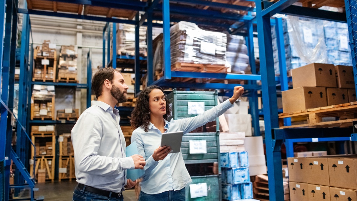 Manager and supervisor taking inventory in warehouse